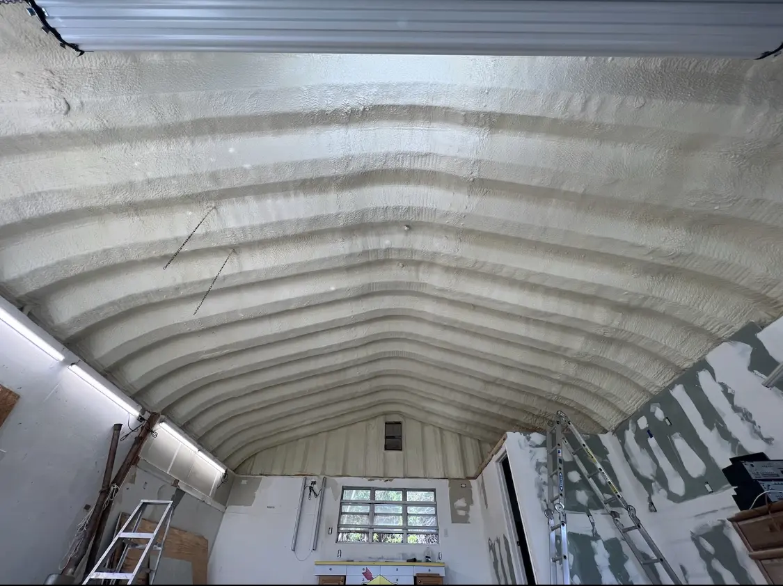 Spray polyurethane foam applied to the underside of a metal roof deck in Durant